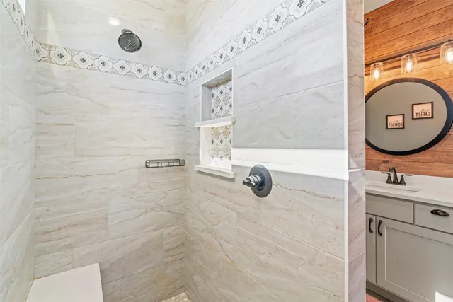 a bathroom with a sink mirror and vanity