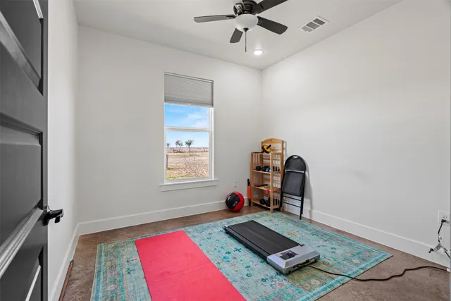 a room with gym equipment and a window