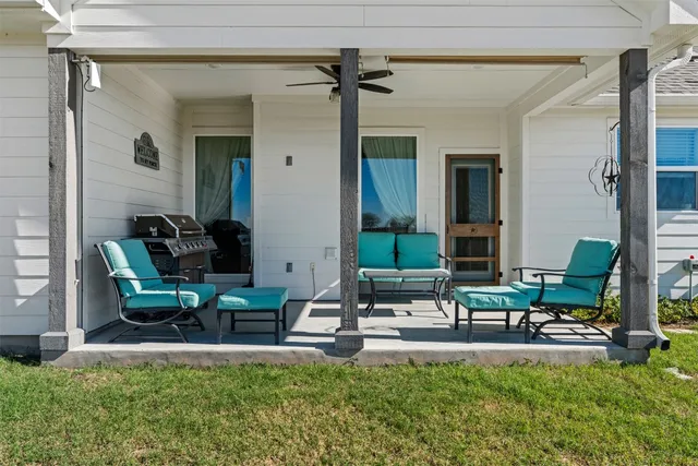 a living room with furniture and a floor to ceiling window