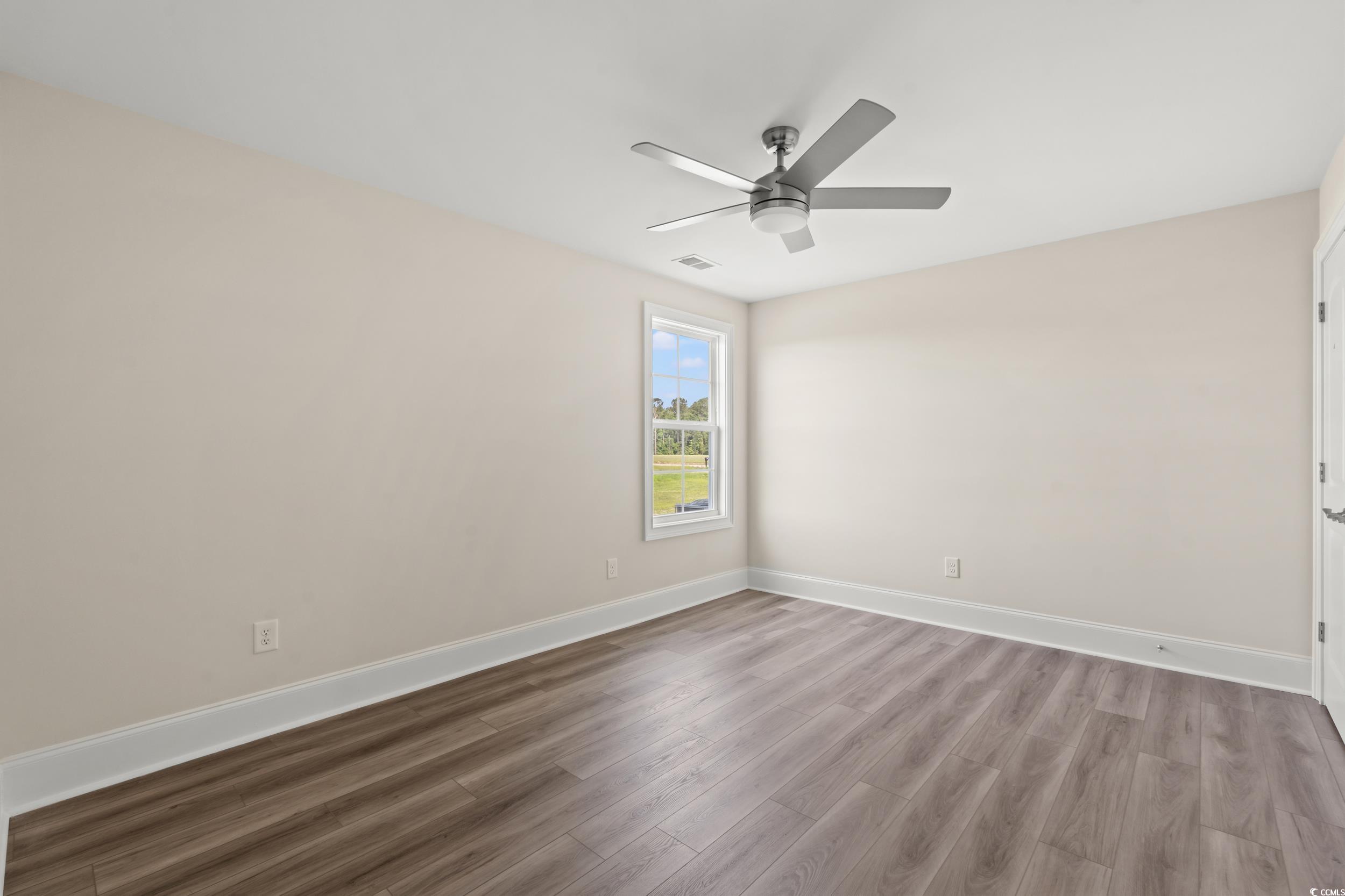4022 Macks Road Aynor, SC 29511 - Photo 19 of 35 Spare room featuring a ceiling fan, wood finished floors, and baseboards