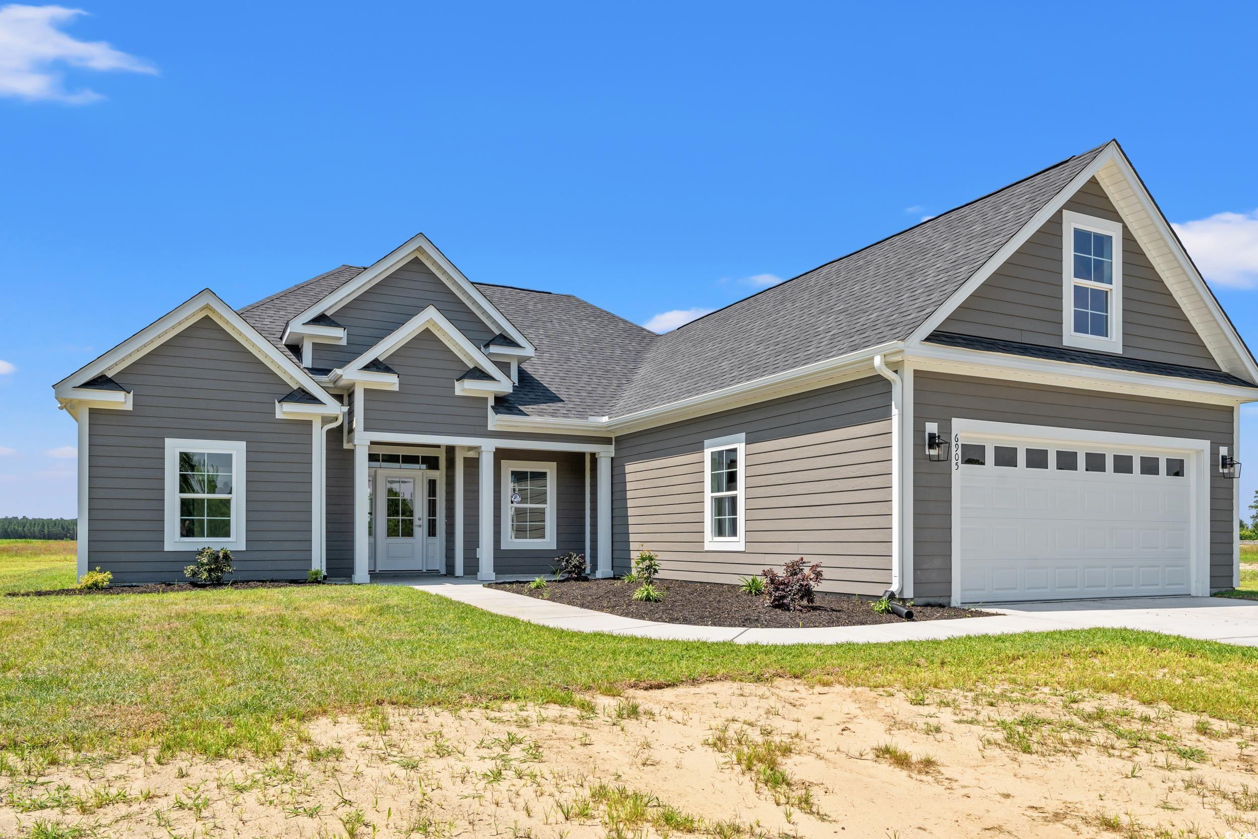 4022 Macks Road Aynor, SC 29511 - Photo 27 of 35 Traditional-style home with concrete driveway, a front lawn, and a shingled roof
