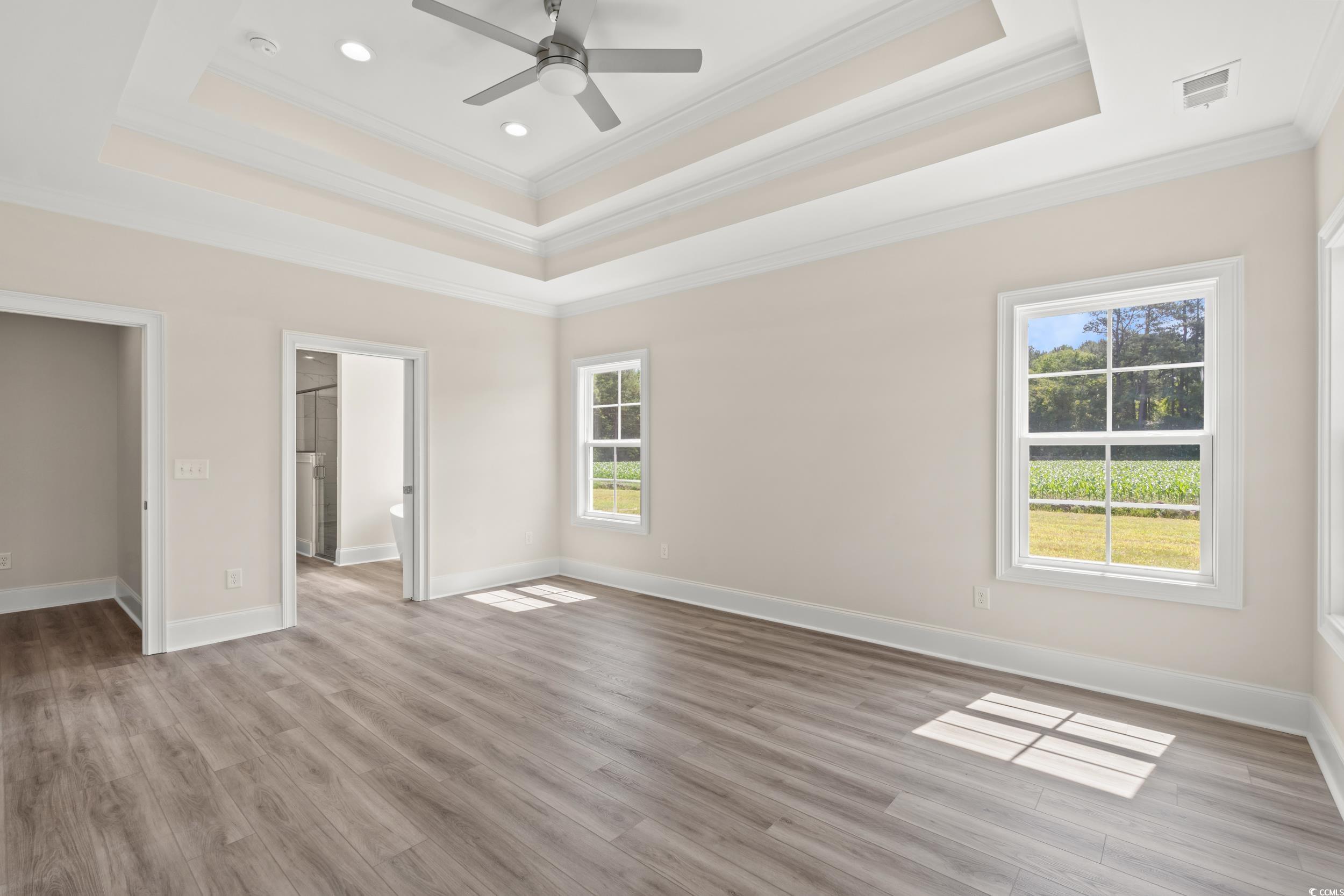 4022 Macks Road Aynor, SC 29511 - Photo 10 of 35 Unfurnished bedroom with crown molding, a tray ceiling, light wood finished floors, recessed lighting, and baseboards