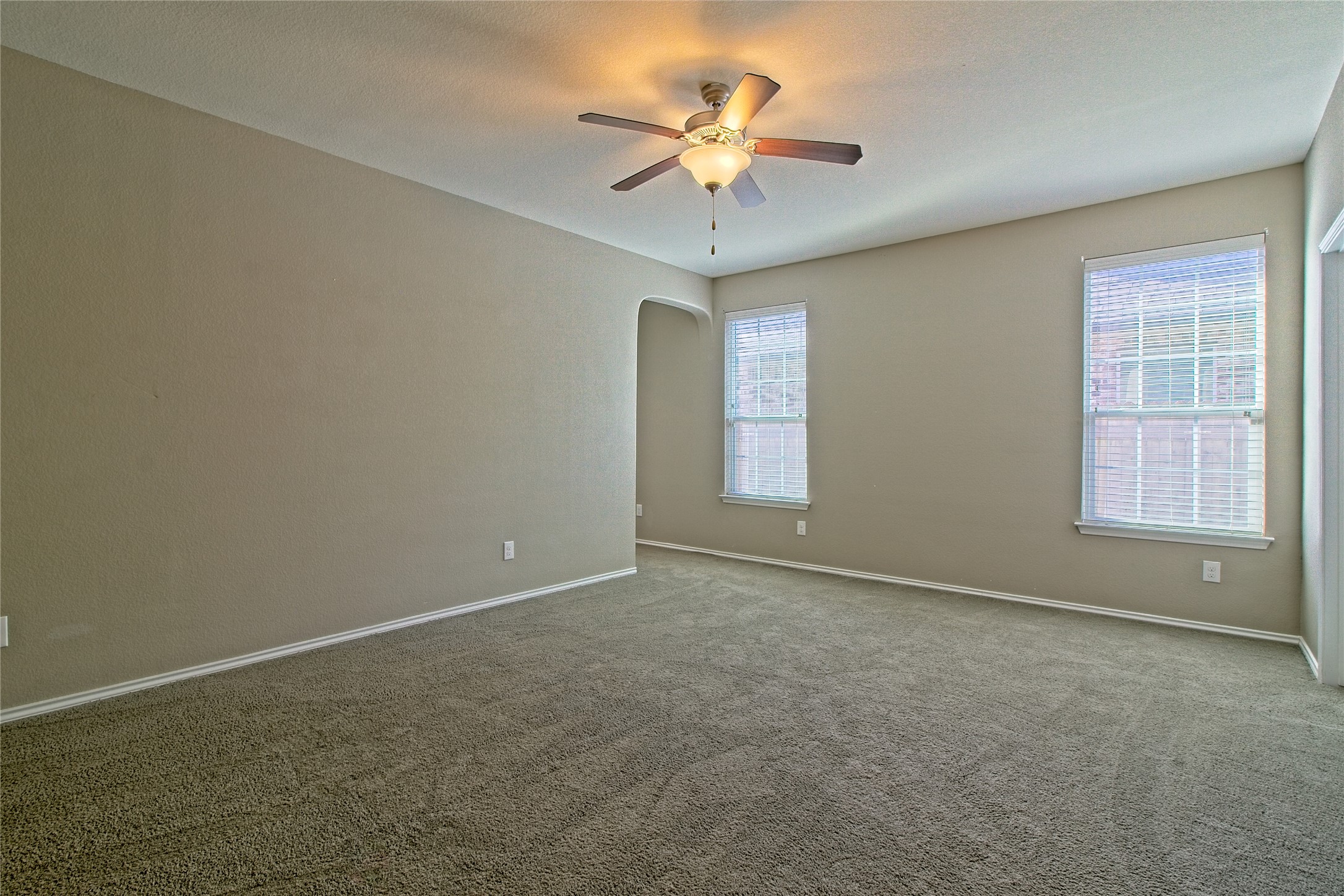31443 Kingsway Road Georgetown, TX 78628 - Photo 16 of 40 A spacious room offers comfortable carpet flooring and natural illumination through multiple windows.