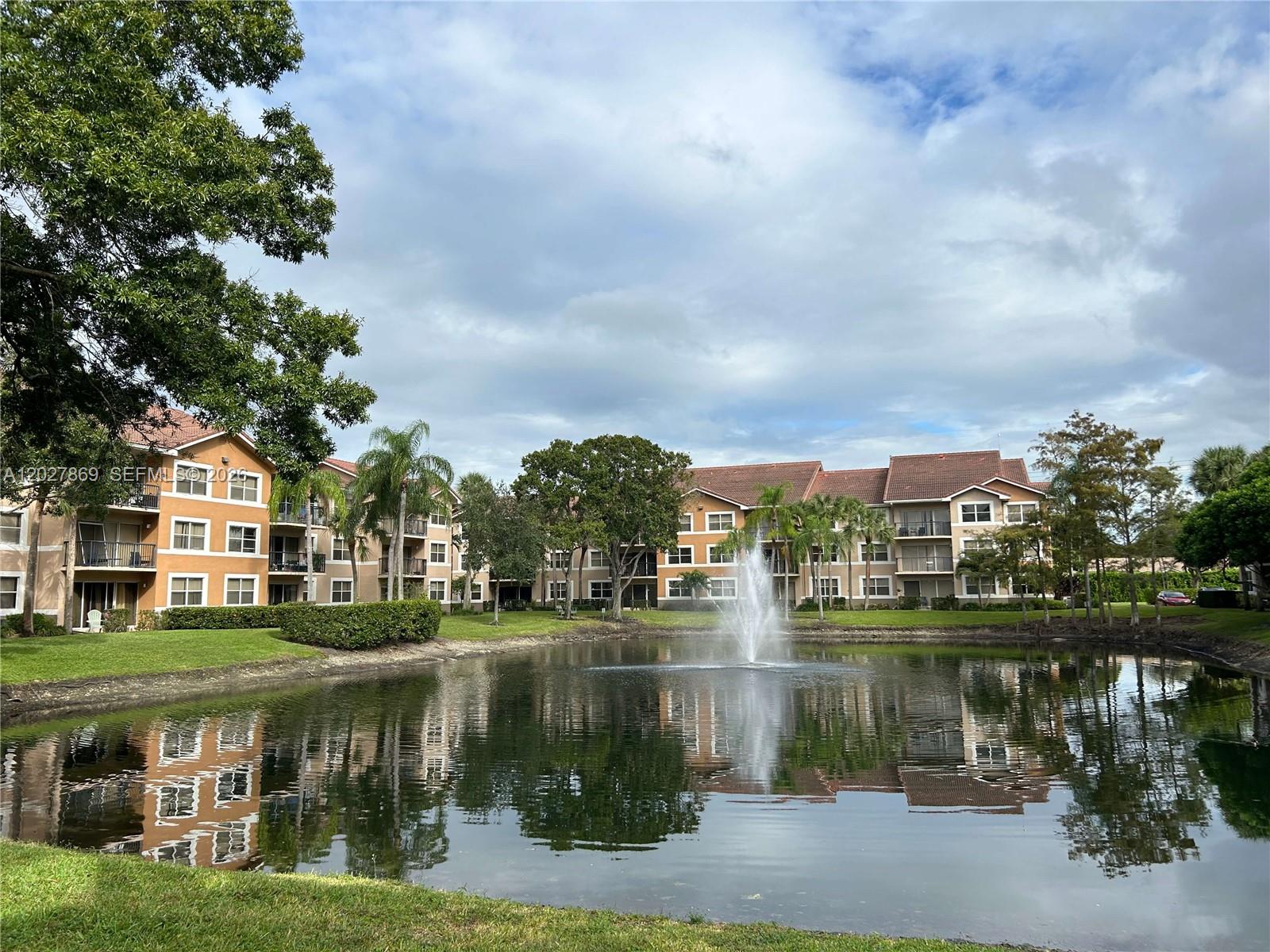 8761 Wiles Road, Unit 206 Coral Springs, FL 33067 - Photo 15 of 26 a view of a lake with a building in the background