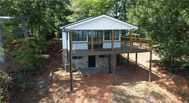 a view of a house with backyard porch and sitting area