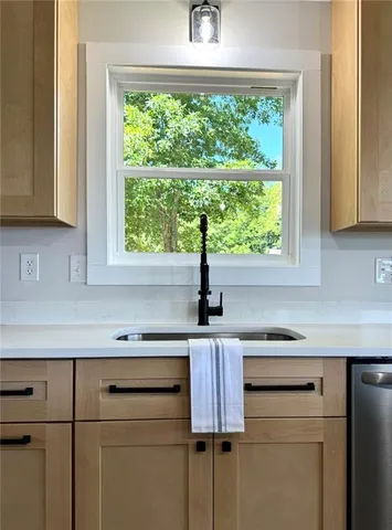 a kitchen with a sink and a window