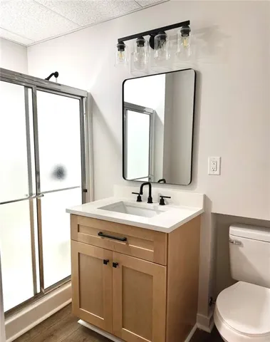 a bathroom with a toilet sink and mirror
