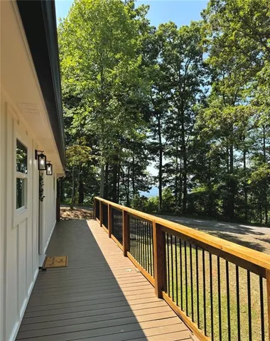 a view of a house with a yard and hanging chair
