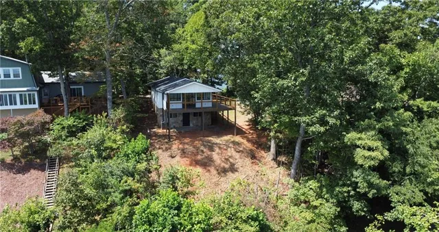 a view of a house with a tree in front of it