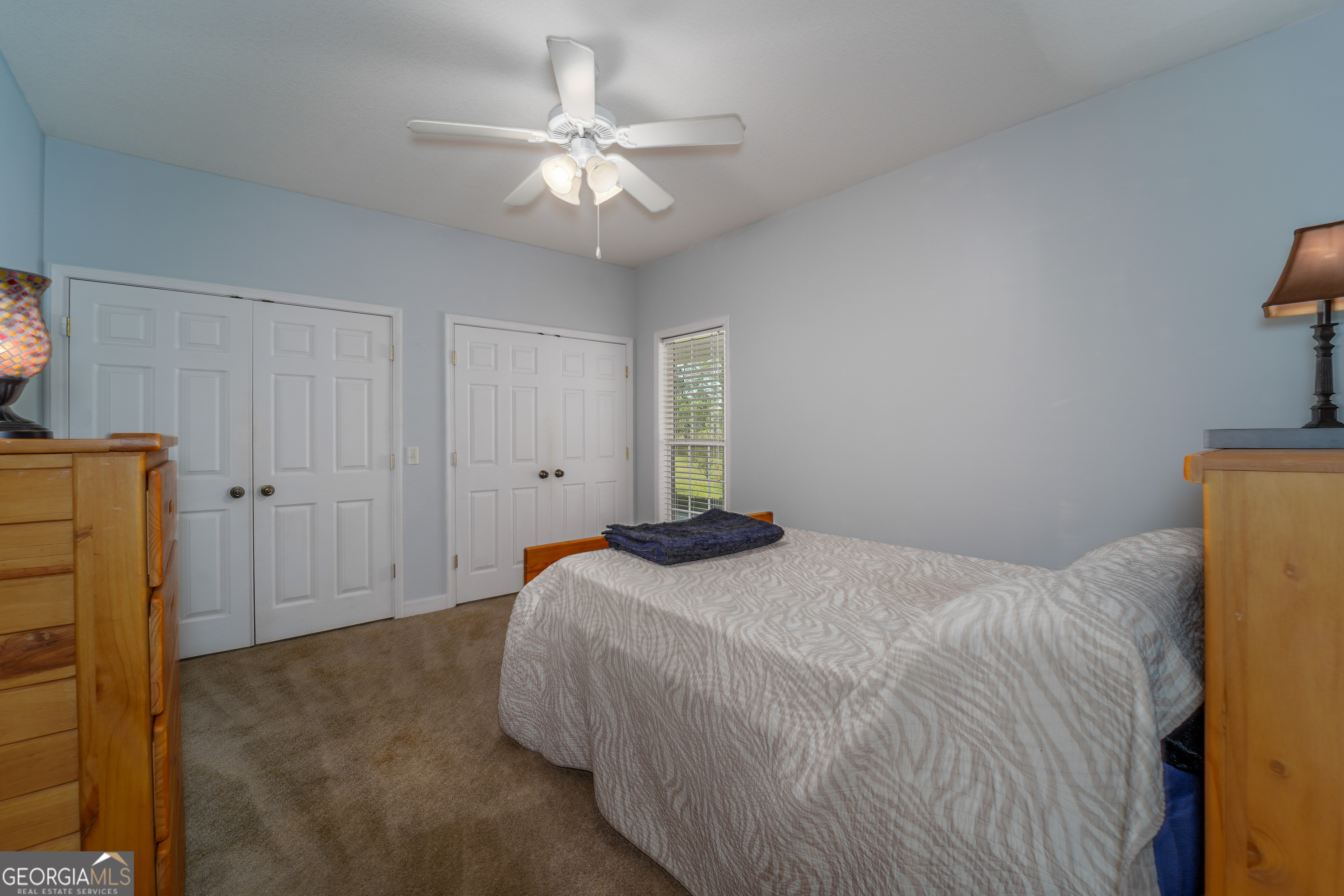 3300 Connor Lane Waycross, GA 31503 - Photo 35 of 42 a bedroom with a bed and a chandelier
