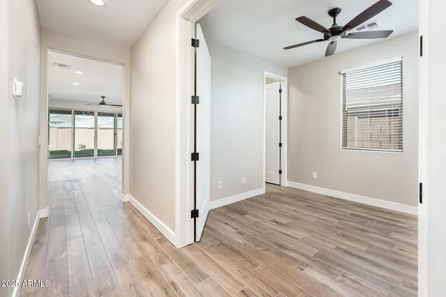 wooden floor in an empty room with a window