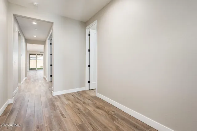 a view of a hallway with wooden floor