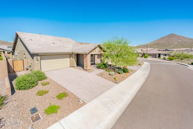 a view of a house with a yard and potted plants