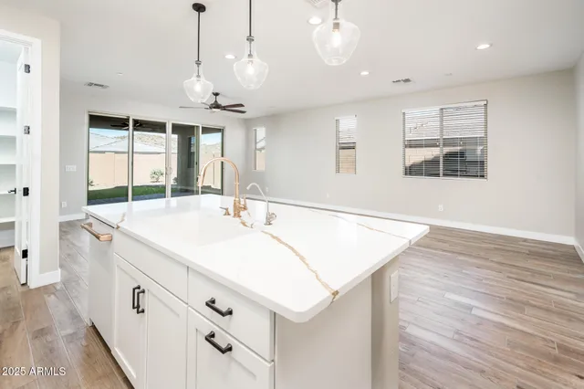 a bathroom with a sink a large mirror and vanity