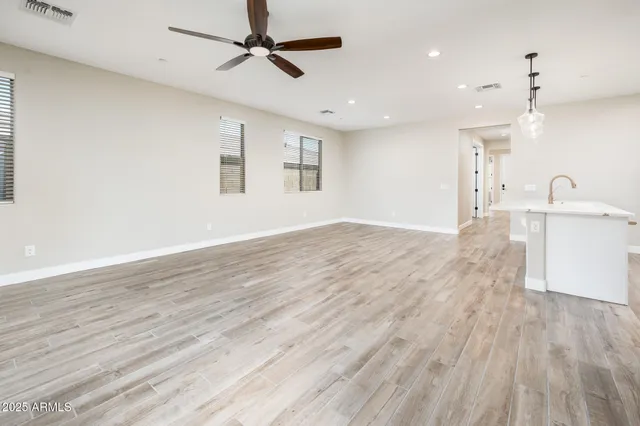 a view of a kitchen with a sink and wooden floor