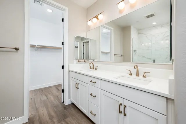 a spacious bathroom with a double vanity sink double and mirror