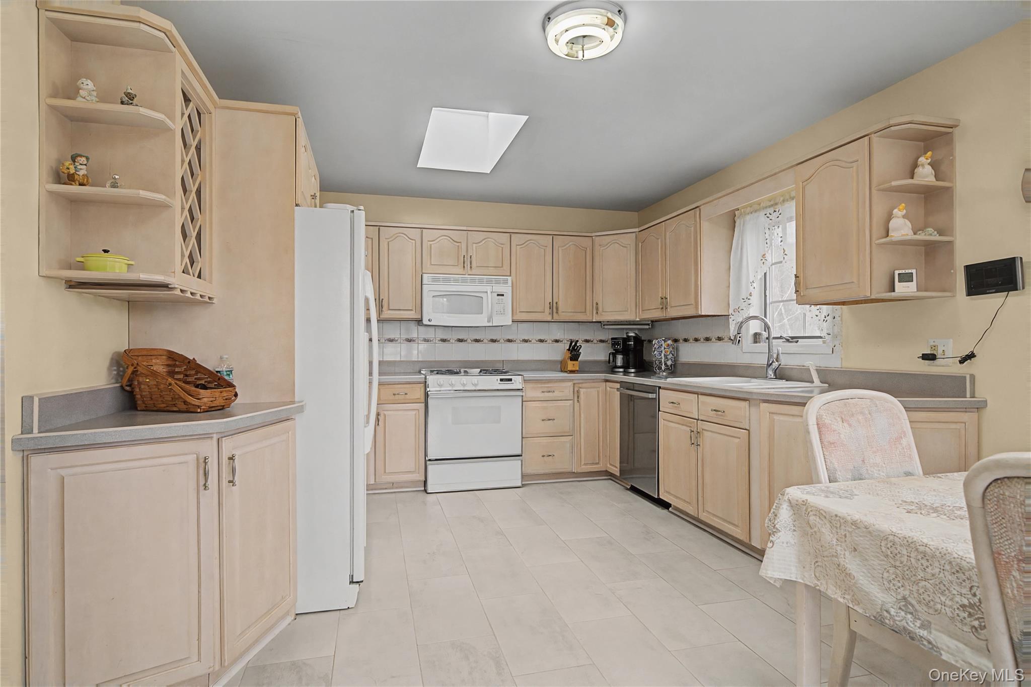 6 Adams Court Monroe, NY 10950 - Photo 12 of 44 a kitchen with white cabinets and white appliances