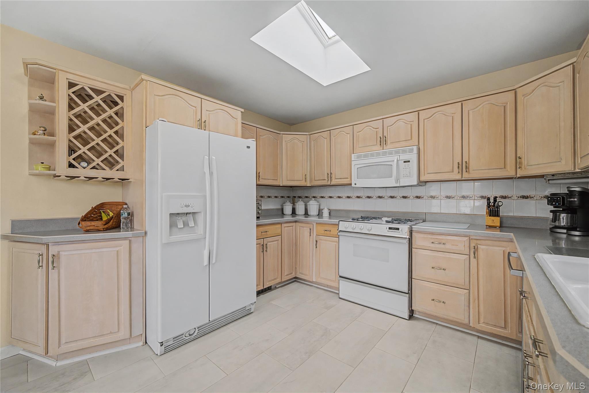 6 Adams Court Monroe, NY 10950 - Photo 16 of 44 a kitchen with granite countertop white cabinets and white appliances