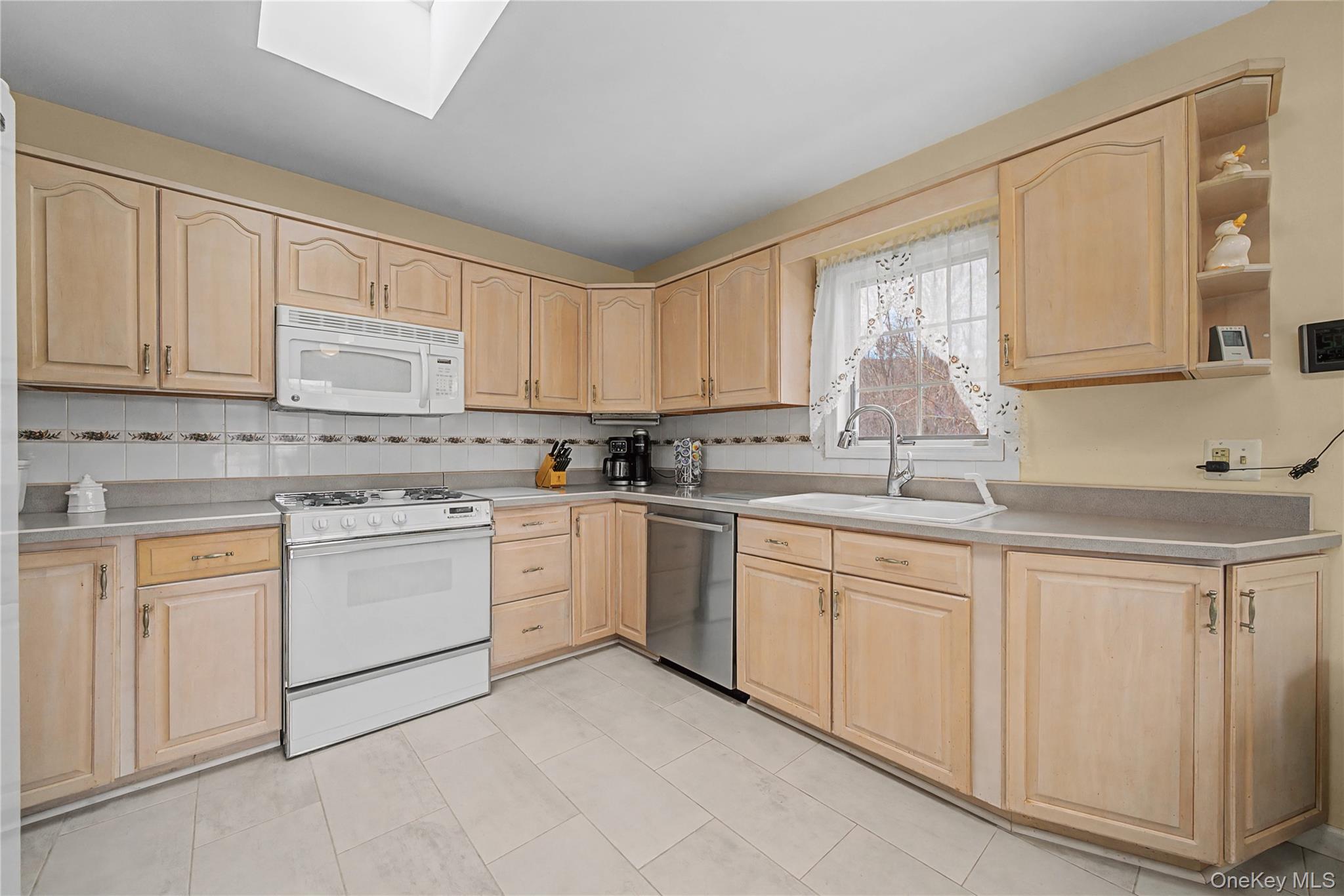 6 Adams Court Monroe, NY 10950 - Photo 17 of 44 a kitchen with granite countertop white cabinets sink and white appliances