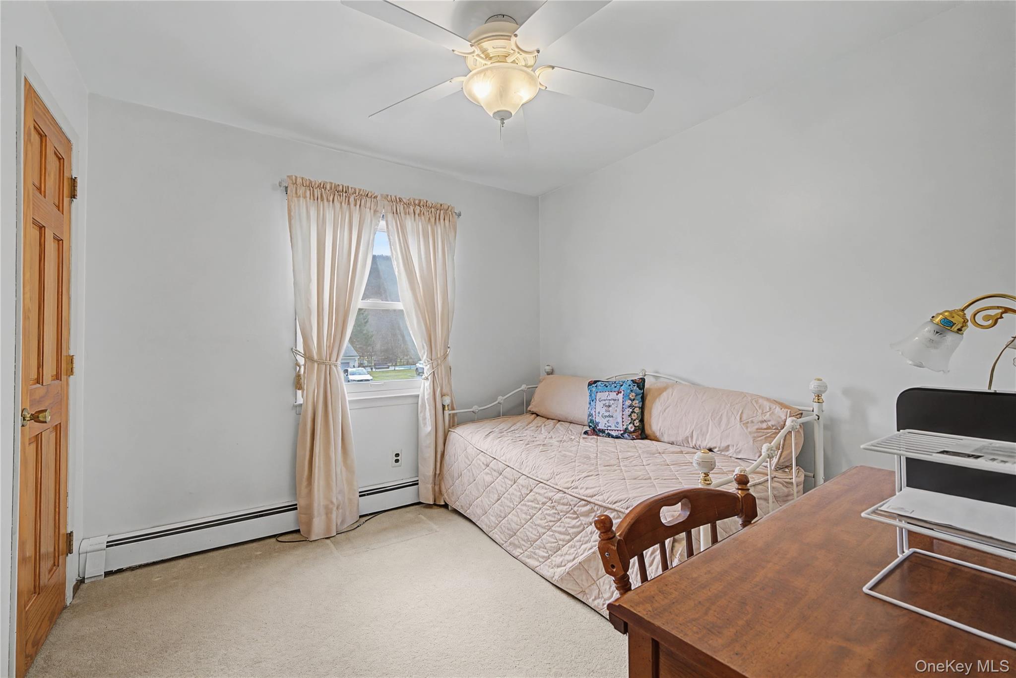 6 Adams Court Monroe, NY 10950 - Photo 20 of 44 a bedroom with furniture and a chandelier