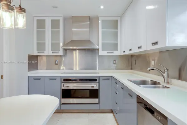 a kitchen with cabinets appliances and a sink