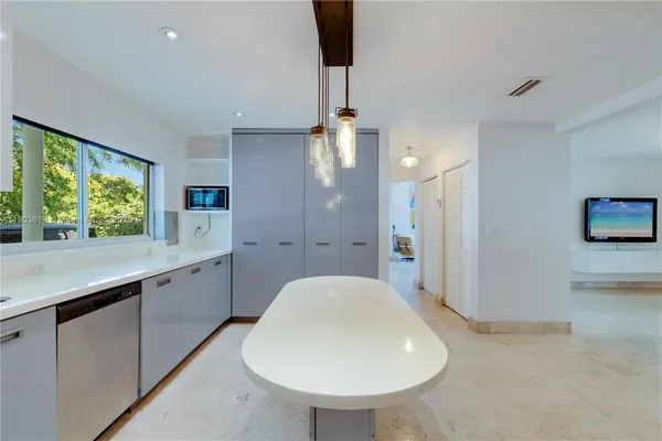 a kitchen with stainless steel appliances a sink cabinets and wooden floor