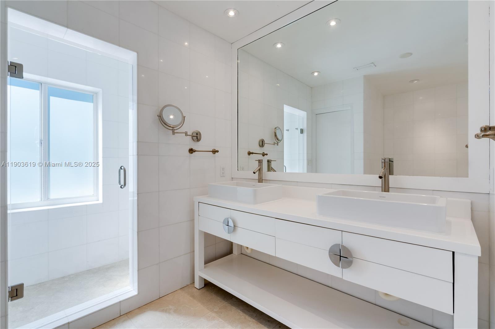 525 Ridgewood Road Key Biscayne, FL 33149 - Photo 54 of 58 a bathroom with a double vanity sink mirror and shower