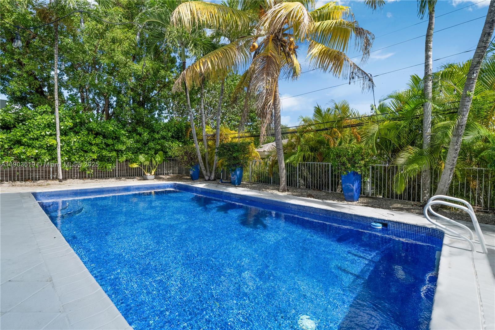 525 Ridgewood Road Key Biscayne, FL 33149 - Photo 56 of 58 a view of a swimming pool with a yard