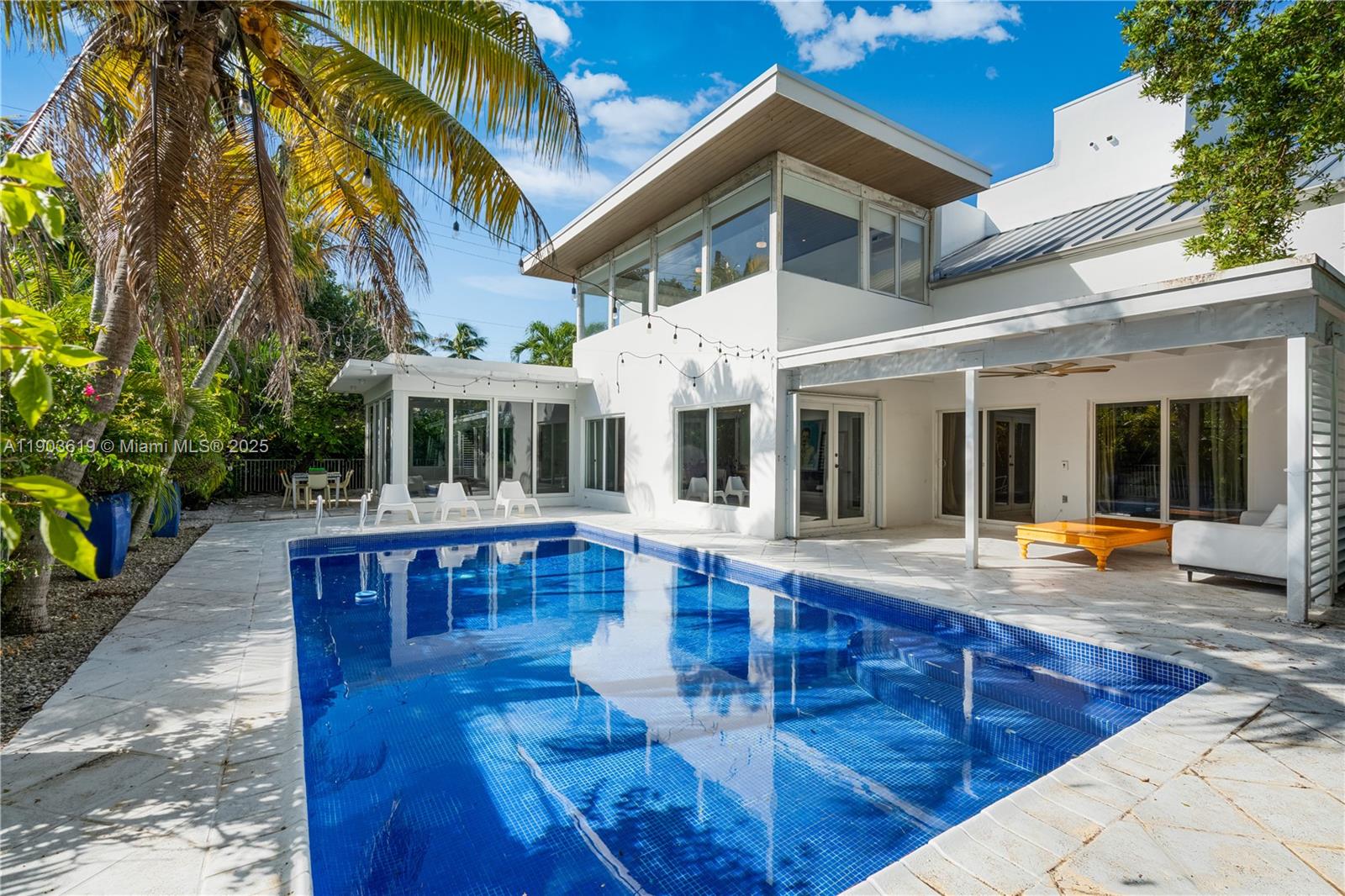 525 Ridgewood Road Key Biscayne, FL 33149 - Photo 6 of 58 a view of a house with swimming pool and sitting area