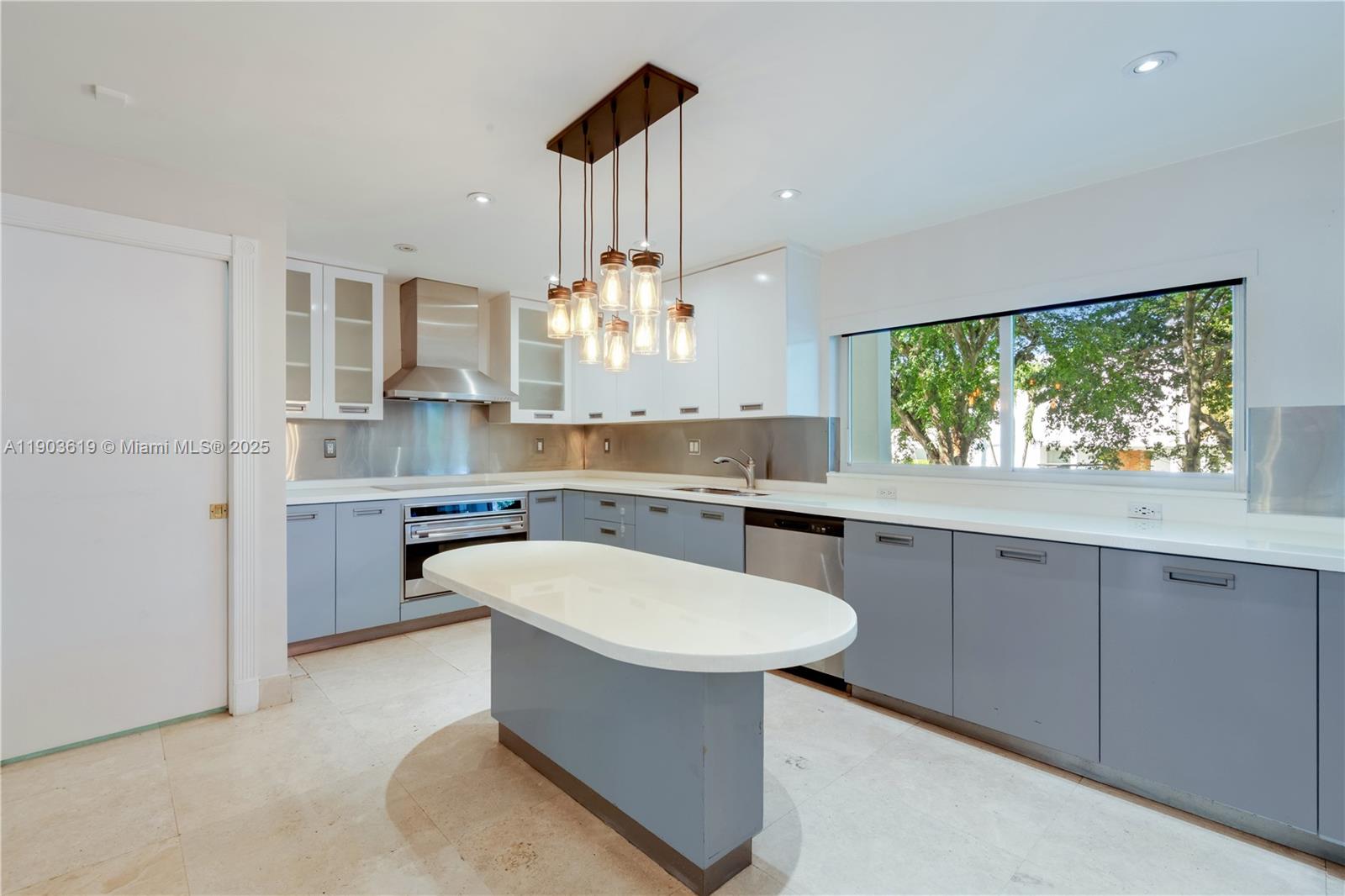 525 Ridgewood Road Key Biscayne, FL 33149 - Photo 9 of 58 a kitchen with a sink cabinets and window