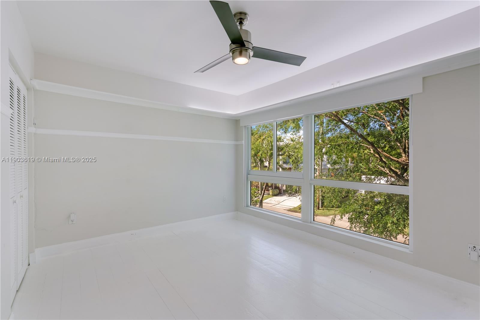 525 Ridgewood Road Key Biscayne, FL 33149 - Photo 10 of 58 an empty room with a window