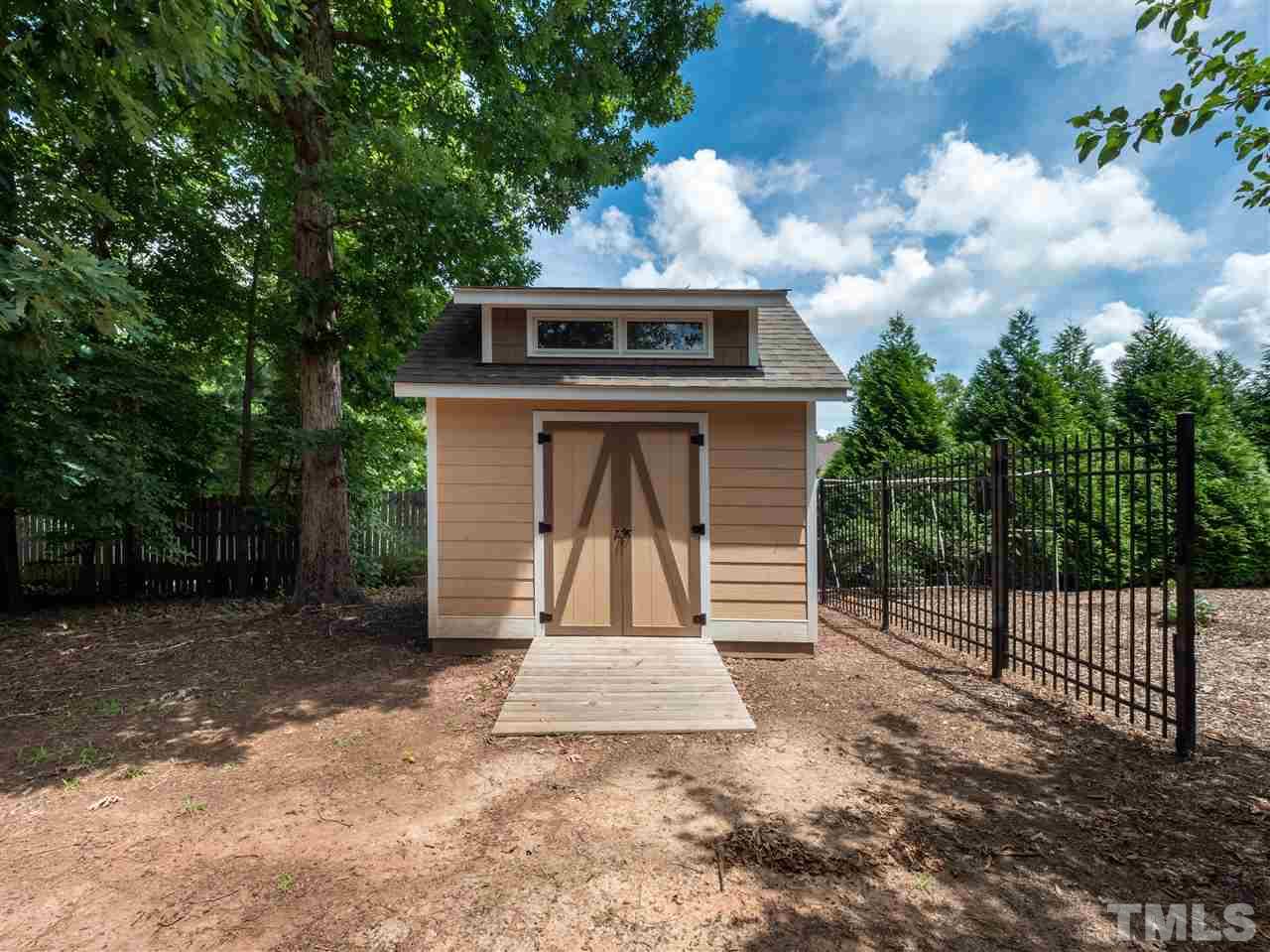 2512 Brook Crossing Circle Raleigh, NC 27606 - Photo 25 of 28 a view of house with a small yard and large tree