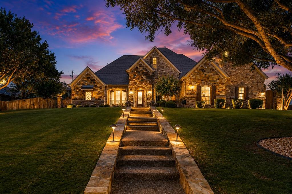 229 Arbor Lane Haslet, TX 76052 - Photo 1 of 35 Stone facade residence featuring a multi-gabled roofline and an inviting stone pathway
