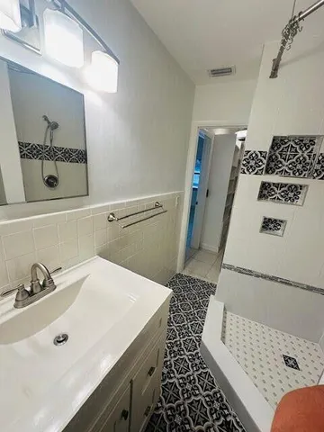 a bathroom with a sink and a mirror