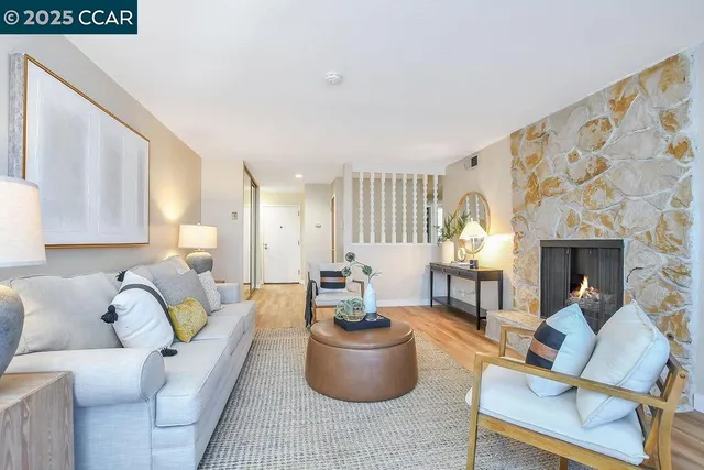 a living room with furniture and a fireplace