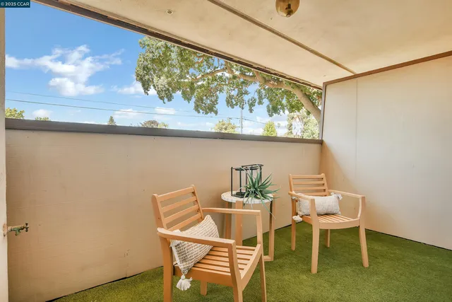 a view of a dining room with furniture and a window