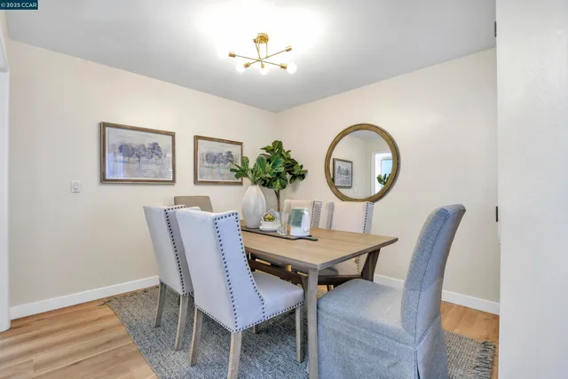 a view of a dining room with furniture and a chandelier