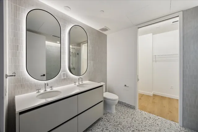 a bathroom with a double vanity sink and a mirror
