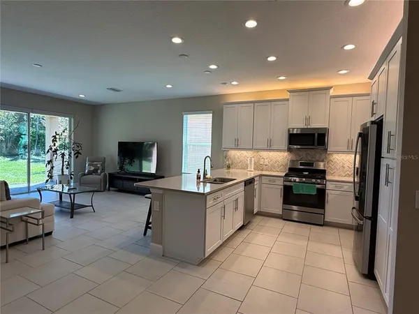 a living room with couches and a flat screen tv