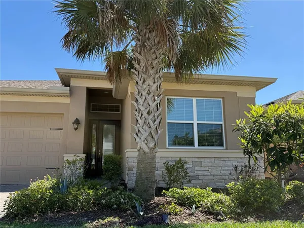 a front view of a house with a plants