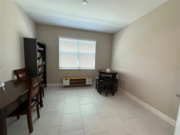 a bedroom with a bed and a lamp
