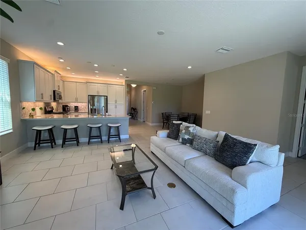 a kitchen with stainless steel appliances a stove a sink a microwave a refrigerator and cabinets