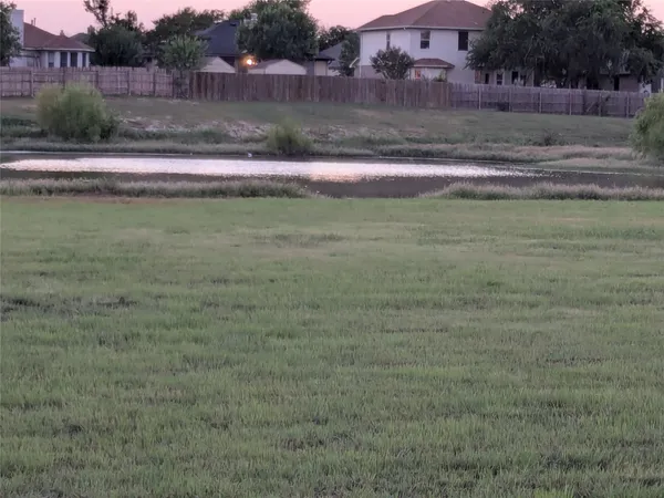 a view of grassy field with trees