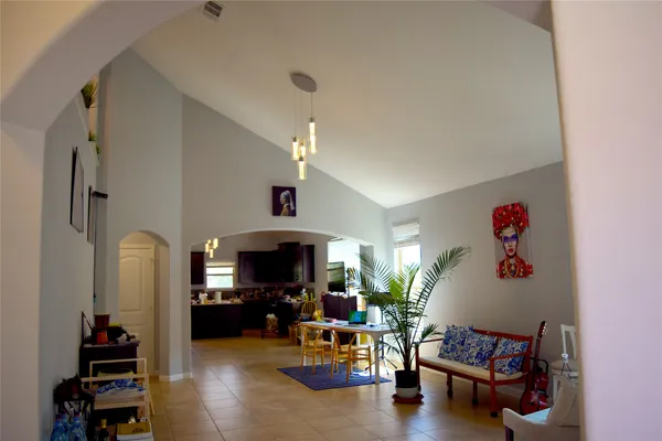a living room with furniture and a chandelier