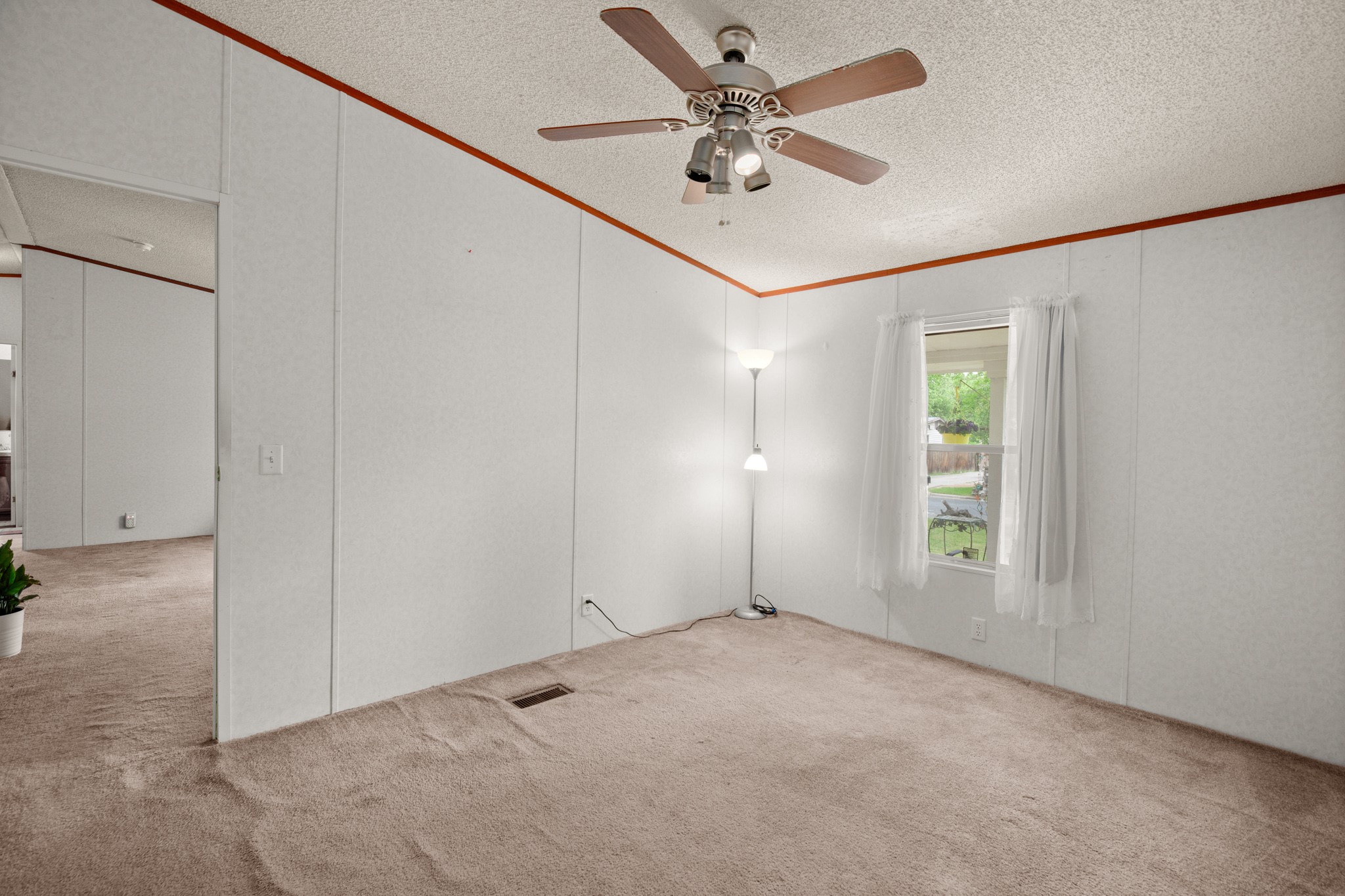 1104 Vasquez Street Austin, TX 78741 - Photo 11 of 18 an empty room with windows and fan
