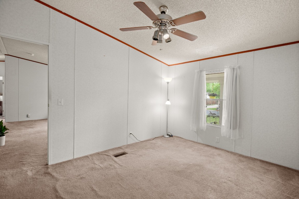1104 Vasquez Street Austin, TX 78741 - Photo 11 of 18 an empty room with windows and fan