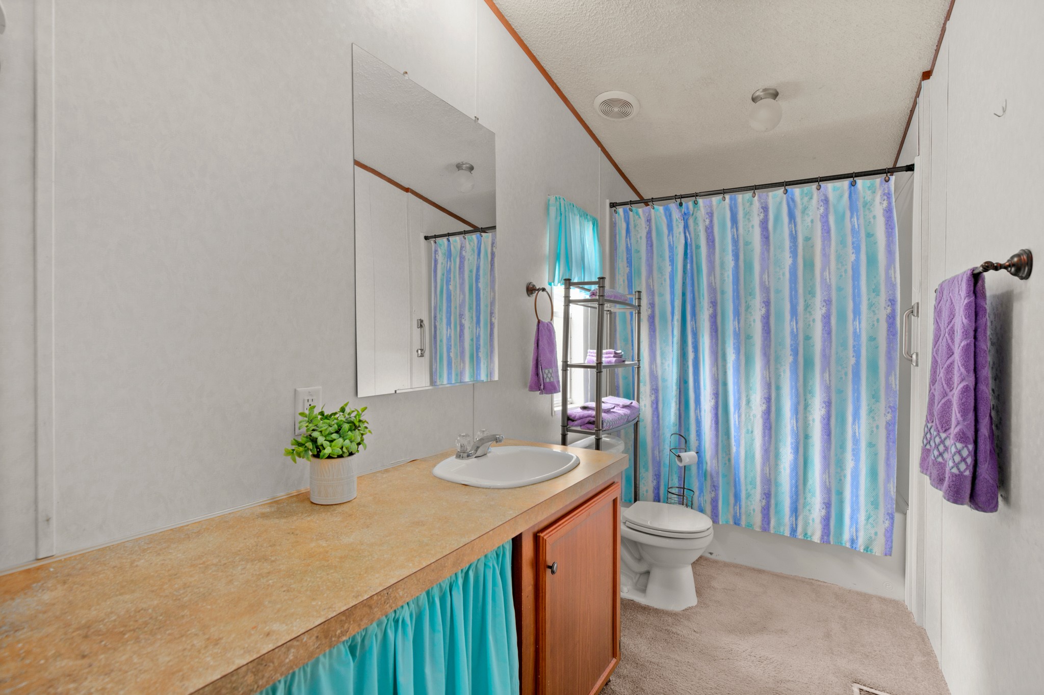 1104 Vasquez Street Austin, TX 78741 - Photo 12 of 18 a spacious bathroom with a granite countertop sink and a mirror