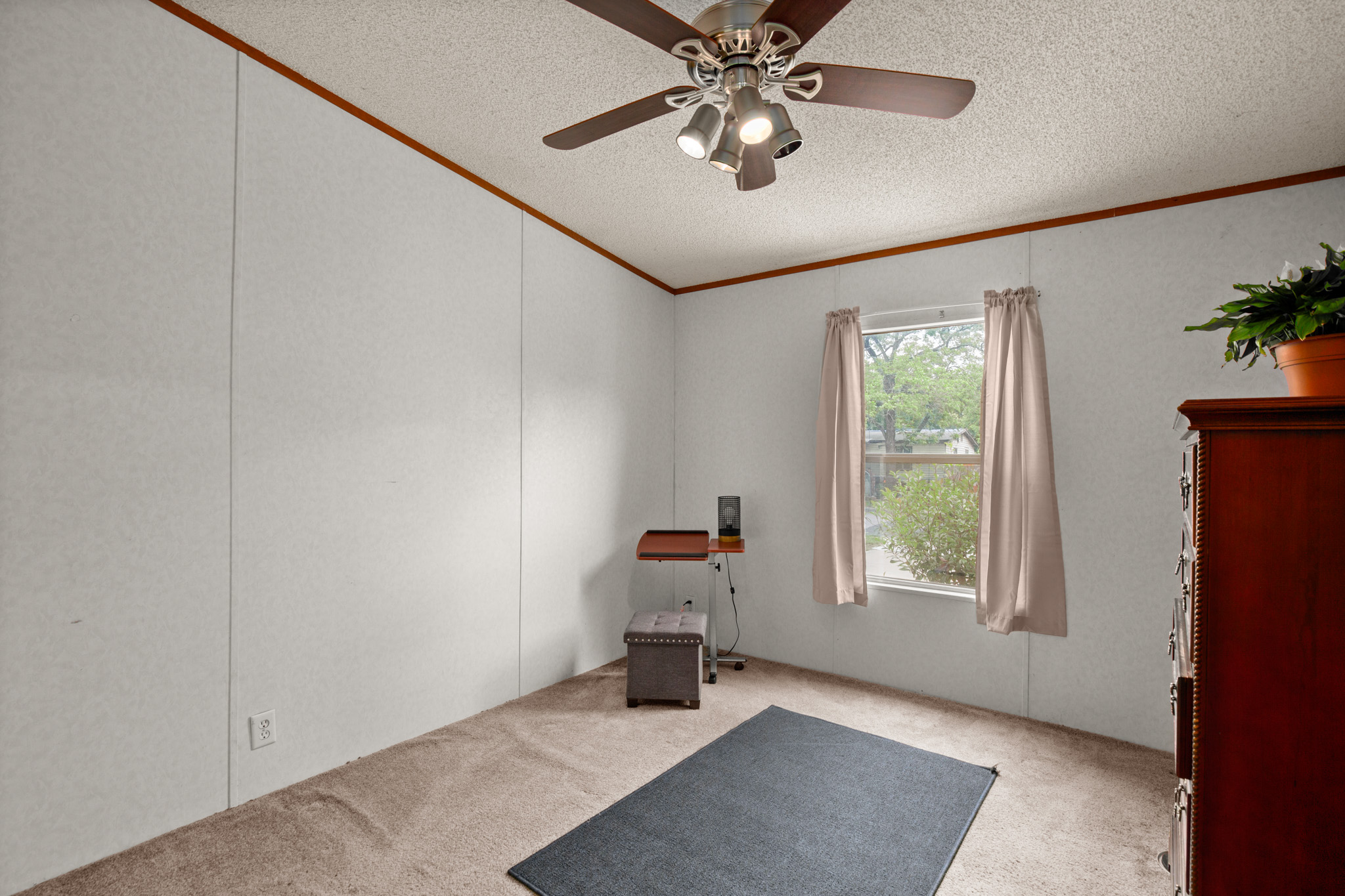 1104 Vasquez Street Austin, TX 78741 - Photo 13 of 18 an empty room with windows and chandelier fan