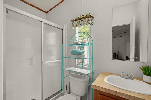 a bathroom with a sink toilet and shower