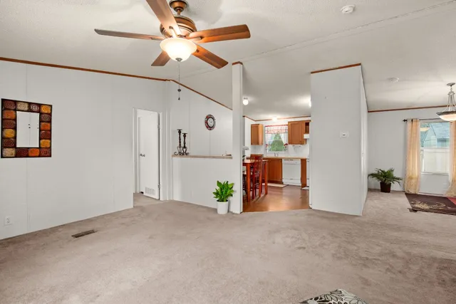 a view of a livingroom with furniture and a ceiling fan